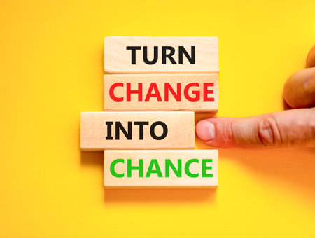 Turn change into chance symbol. Concept words phrase Turn change into chance on beautiful wooden blocks. Beautiful yellow paper background. Business Turn change into chance concept. Copy space.の写真素材