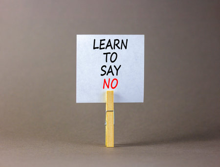 Learn to say no symbol. Concept words phrase Learn to say no on beautiful white paper on wooden clothespin. Beautiful gray paper background. Business psychological Learn to say no concept Copy spaceの写真素材