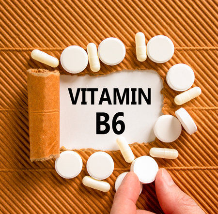 Vitamin B6 symbol. Concept words Vitamin B6 on beautiful white paper. White pills tablets. Doctor's hand. Beautiful brown background. Medical healthy lifestyle Vitamin B6 concept.の写真素材