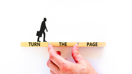 Turn the page symbol. Concept words Turn the page on beautiful wooden block. Businessman's hand. Beautiful white background. Business motivational lifestyle turn the page concept. Copy space.の写真素材