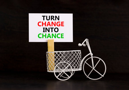 Turn change into chance symbol. Concept words phrase Turn change into chance on beautiful white paper on clothespin. Beautiful black background. Business Turn change into chance concept. Copy space.の写真素材