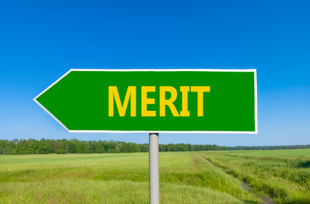 Merit symbol. Concept word Merit on beautiful green road sign. Beautiful blue sky green grass and forest peaceful nature background. Business lifestyle merit concept. Copy space.の写真素材