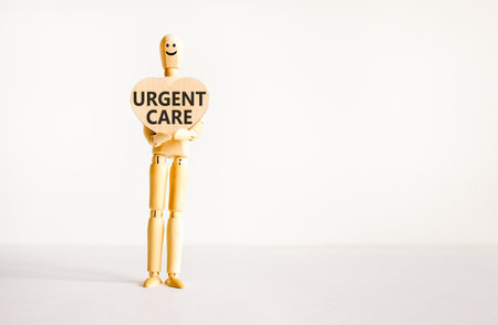Urgent care symbol. Concept words Urgent care on beautiful wooden heart. Doctor's model. Beautiful white background. Copy space. Medical healthy lifestyle urgent care concept.の写真素材