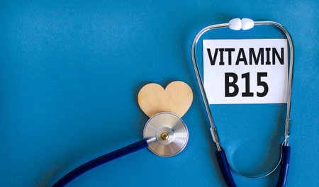 Vitamin B15 pantothenic acid symbol. Concept words Vitamin B15 on beautiful white card. Wooden heart and stethoscope. Beautiful blue background. Medical healthy lifestyle Vitamin B15 concept.の写真素材