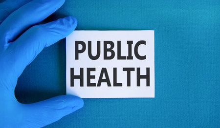 Public health symbol. Concept words Public health on beautiful white card. Doctor's hand in blue...