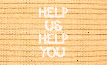 Help you symbol. Concept words phrase Help us help you on beautiful brown brick wall. Beautiful...