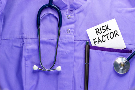 Risk factor symbol. Concept words Risk factor on beautiful white card. Stethoscope and pen....