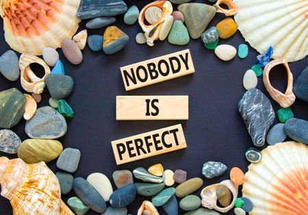 Nobody is perfect symbol. Concept words Nobody is perfect on beautiful block. Sea stones shells....