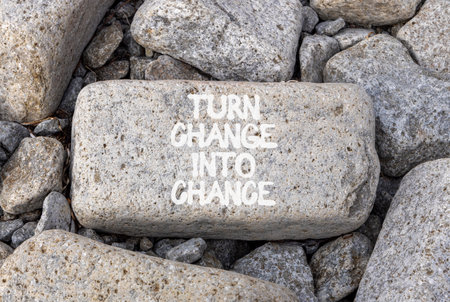 Turn change into chance symbol. Concept words phrase Turn change into chance on beautiful gray stone. Beautiful gray stone beach background. Business Turn change into chance concept. Copy space.の写真素材