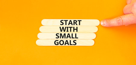 Start with small goals symbol. Concept words phrase Start with small goals on beautiful stick....