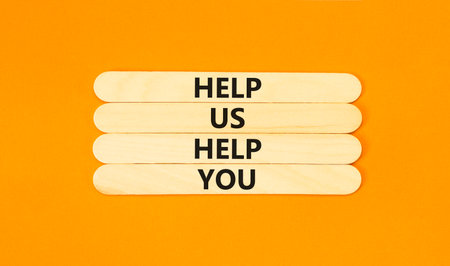 Help you symbol. Concept words phrase Help us help you on beautiful wooden stick. Beautiful orange paper background. Business Help you concept. Copy space.の写真素材
