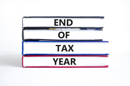 End of tax year symbol. Concept words phrase End of tax year on beautiful books. Beautiful white...