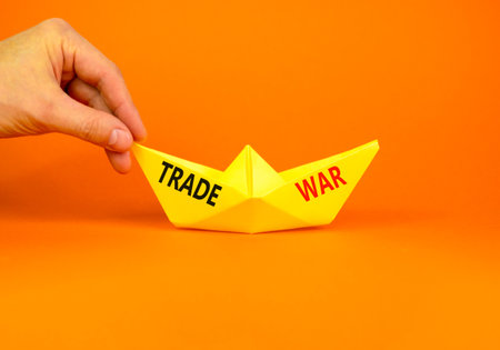 Trade war symbol. Concept word Trade war on beautiful yellow paper boat. Businessman's hand....