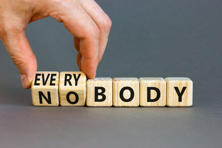 Everybody vs nobody symbol. Concept words Everybody and Nobody on wooden cubes. Beautiful gray table...