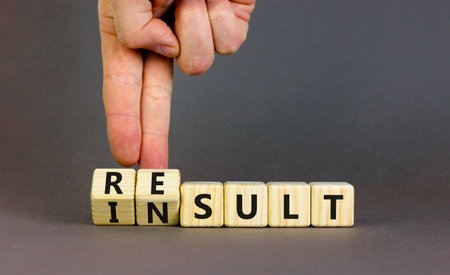 Result or insult symbol. Concept words Result Insult on wooden cubes. Beautiful gray table gray...