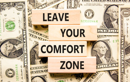 Leave your comfort zone symbol. Concept words Leave your comfort zone on beautiful wooden blocks. Beautiful dollar bills background. Business psychological Leave your comfort zone concept. Copy space.の写真素材
