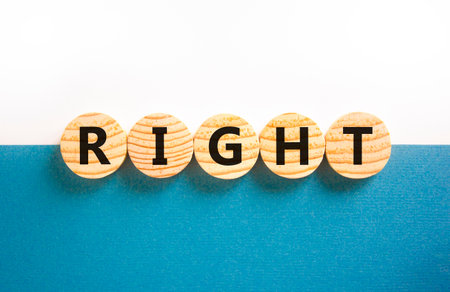 Right symbol. Concept word Right on beautiful wooden circles. Beautiful white and blue background....