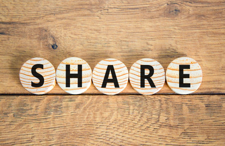 Share symbol. Concept word Share on beautiful wooden circles. Beautiful wooden table wooden...
