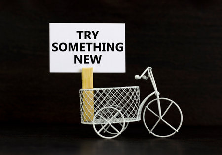 Try something new symbol. Concept words Try something new on beautiful white paper on clothespin. Beautiful black background. Business motivational lifestyle try something new concept. Copy space.の写真素材