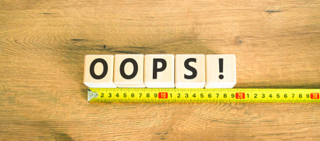 Oops symbol. Concept word Oops on beautiful wooden blocks. Beautiful wooden table wooden background....