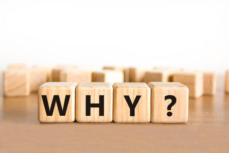 Why question symbol. Concept word Why question on beautiful wooden blocks. Beautiful wooden table white background. Business, lifestyle, support and why question concept. Copy space.の写真素材