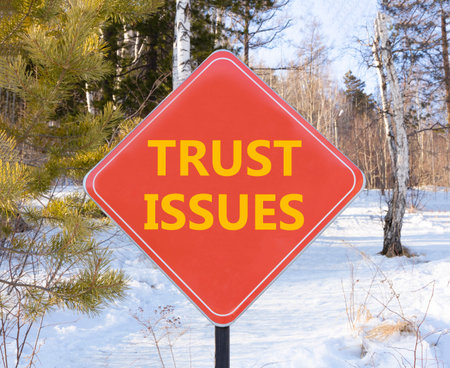 Trust issues symbol. Concept word Trust issues on beautiful red road sign. Beautiful snow winter...