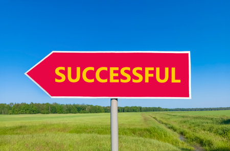 Successful symbol. Concept word Successful on beautiful red road sign. Beautiful blue sky green...