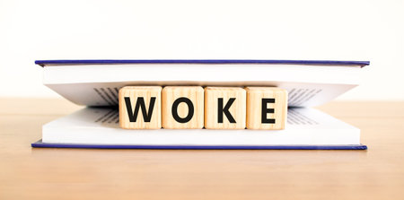 Woke question symbol. Concept word Woke question on beautiful wooden blocks in book. Beautiful...