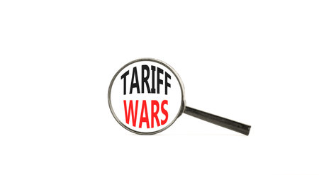 Trade tariff wars symbol. Concept word Tariff wars on beautiful magnifying glass. Beautiful white paper background. Black magnifying glass. Business trade tariff wars concept. Copy space.の写真素材