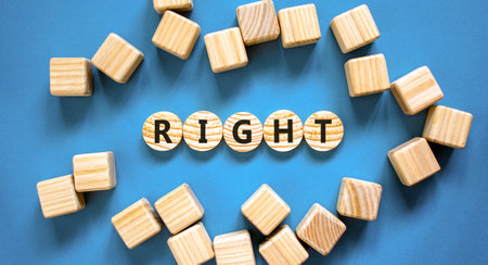 Right symbol. Concept word Right on beautiful wooden circles. Beautiful blue table blue background....