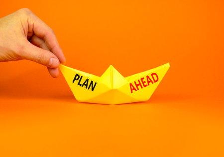 Plan ahead symbol. Concept word Plan ahead on beautiful yellow paper boat. Businessman's hand....