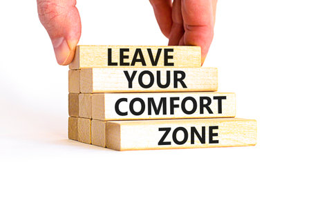 Leave your comfort zone symbol. Concept words Leave your comfort zone on beautiful wooden blocks. Beautiful white paper background. Business psychological Leave your comfort zone concept. Copy space.の写真素材
