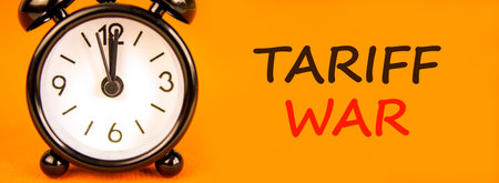 Trade tariff war symbol. Concept word Tariff war on beautiful orange paper. Beautiful black alarm...