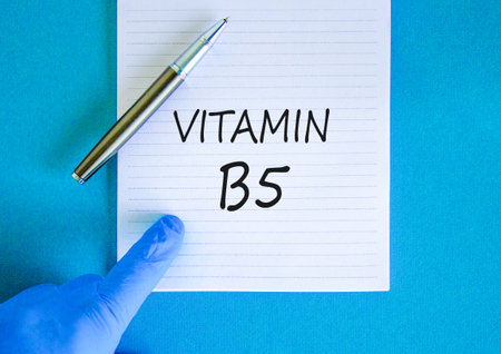 Vitamin B5 pantothenic acid symbol. Concept words Vitamin B5 on beautiful white note. Doctor's hand...