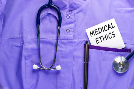 Medical ethics symbol. Concept words Medical ethics on beautiful white card. Stethoscope and pen....