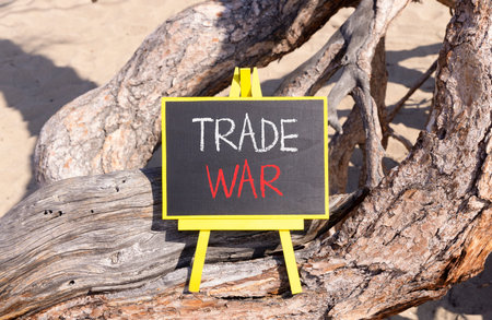 Trade war symbol. Concept word Trade war on beautiful black blackboard. Beautiful old tree...