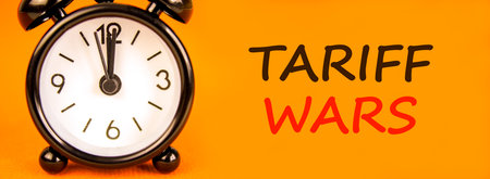 Trade tariff wars symbol. Concept word Tariff wars on beautiful orange paper. Beautiful black alarm...