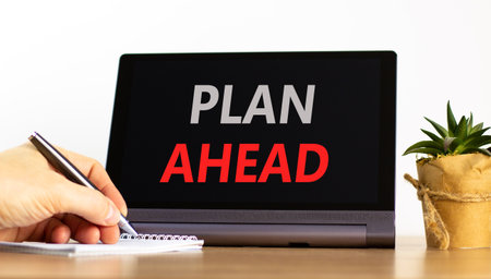 Plan ahead symbol. Concept word Plan ahead on beautiful black tablet. Businessman's hand with pen....