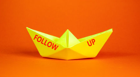 Follow up symbol. Concept word Follow up on beautiful yellow paper boat. Beautiful orange paper...