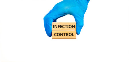 Infection control symbol. Concept words Infection control on beautiful wooden blocks. Doctor's hand...
