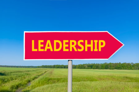 Leadership symbol. Concept word Leadership on beautiful red road sign. Beautiful blue sky green...