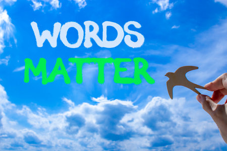 Words matter symbol. Concept word Words matter on beautiful blue sky. Businessman's hand with wooden bird. Beautiful blue sky and cloud background. Business words matter concept. Copy space.の写真素材