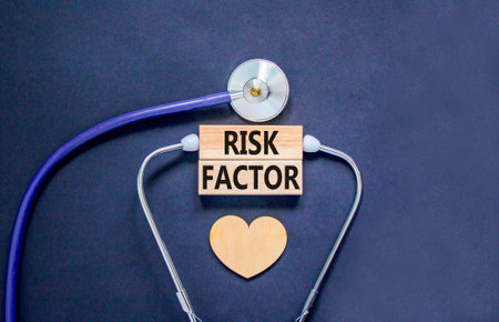 Risk factor symbol. Concept words Risk factor on beautiful wooden blocks. Wooden heart and stethoscope. Beautiful black background. Medical healthy lifestyle risk factor concept.の写真素材