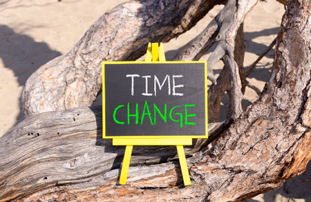 Time change symbol. Concept word Time change on beautiful black blackboard. Beautiful old tree background. Black blackboard. Business time change concept. Copy space.の写真素材