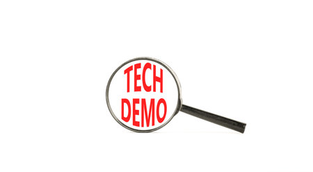 Tech demo symbol. Concept word Tech demo on beautiful magnifying glass. Beautiful white paper...