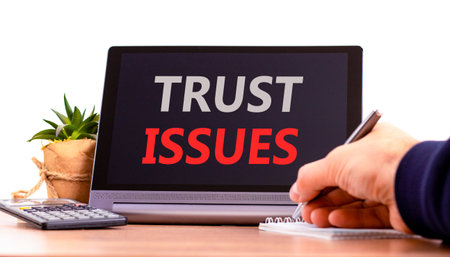 Trust issues symbol. Concept word Trust issues on beautiful black tablet. Businessman's hand with...