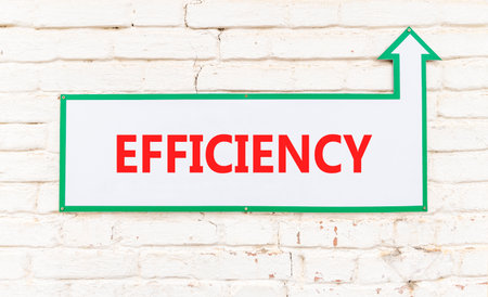 Efficiency symbol. Concept word Efficiency on beautiful white sign on old white brick wall....
