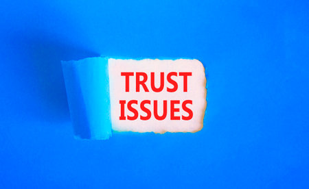Trust issues symbol. Concept word Trust issues on beautiful white paper. Beautiful blue paper background. Business trust issues concept. Copy space.の写真素材