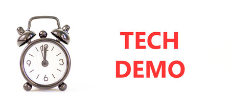 Tech demo symbol. Concept word Tech demo on beautiful white paper. Beautiful black alarm clock....
