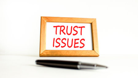 Trust issues symbol. Concept word Trust issues on beautiful wooden picture frame. Black pen. Beautiful white paper background. Business trust issues concept. Copy space.の写真素材